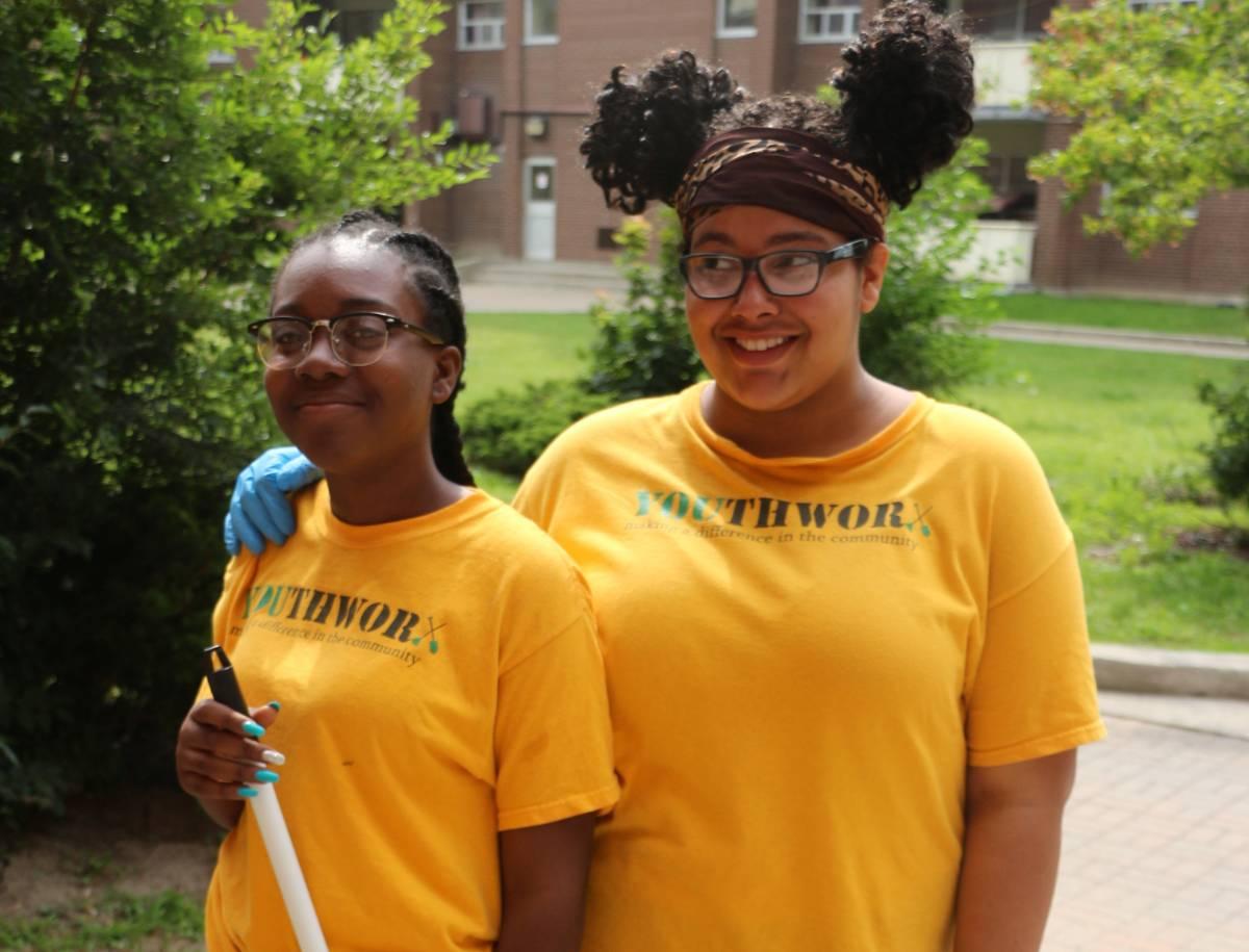Two YouthWorx participants outside posing and smiling.